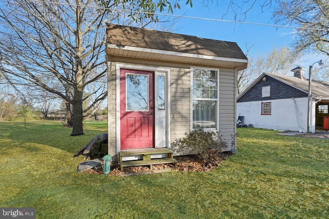 view of outbuilding with a yard