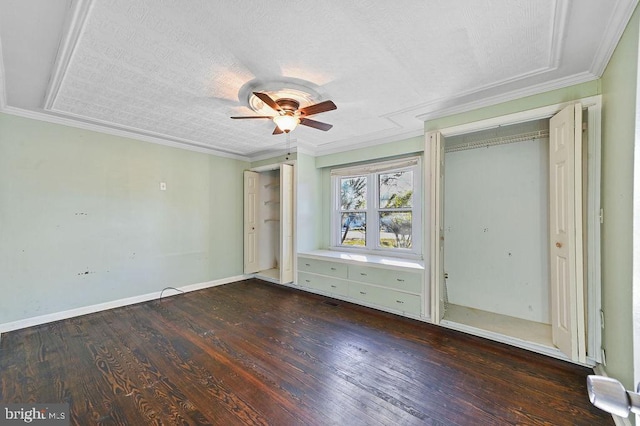 unfurnished bedroom with ceiling fan, crown molding, and dark wood-type flooring