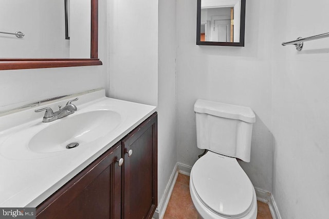 bathroom with tile patterned flooring, vanity, and toilet