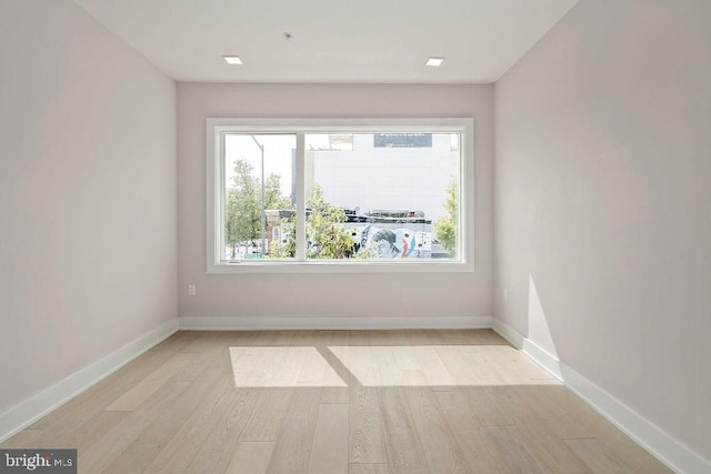 unfurnished room with light wood-type flooring