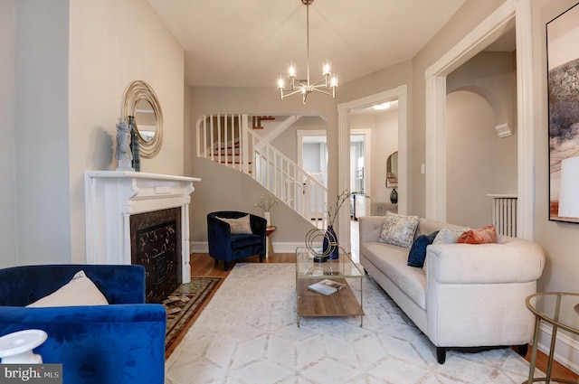 living room featuring light wood-type flooring and a chandelier