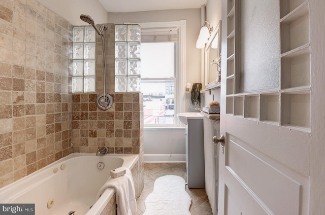 bathroom with tile patterned flooring, vanity, and tiled shower / bath