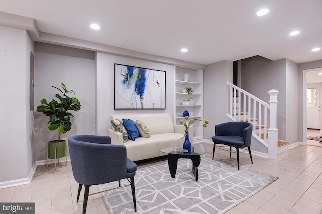 living room featuring light tile patterned flooring and built in features