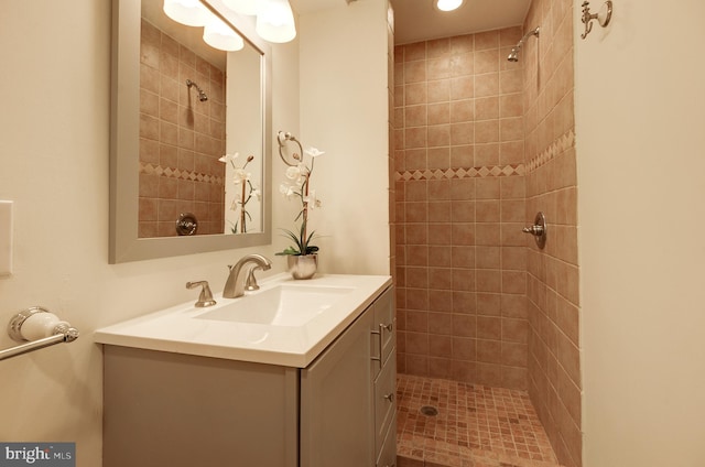 bathroom with vanity and tiled shower