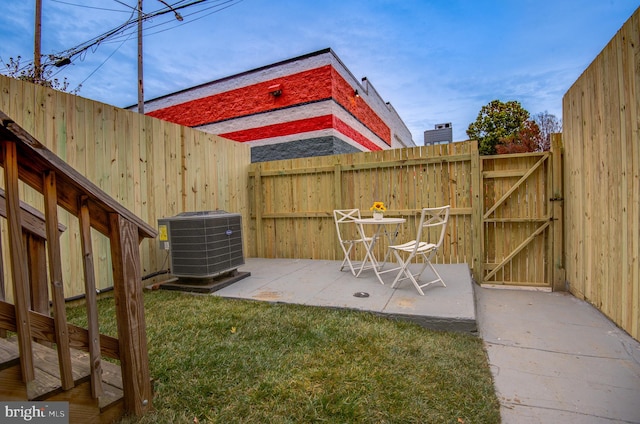 view of yard featuring a patio and central air condition unit