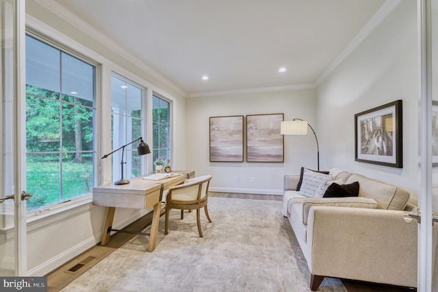 office area with a healthy amount of sunlight, crown molding, and light hardwood / wood-style flooring