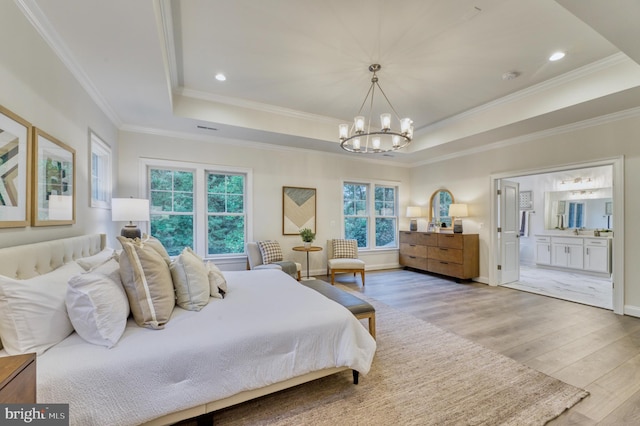 bedroom with multiple windows, ensuite bathroom, light hardwood / wood-style floors, and ornamental molding