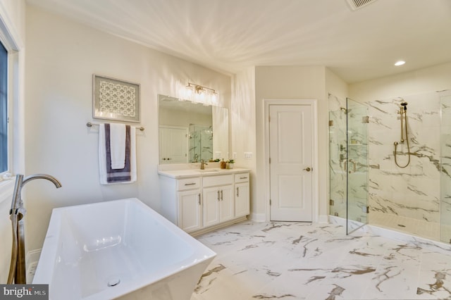 bathroom featuring vanity and independent shower and bath