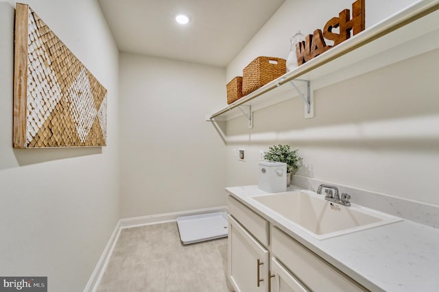 washroom featuring cabinets, sink, and washer hookup