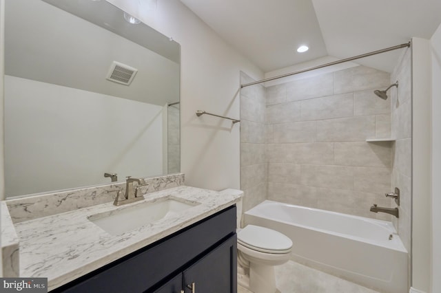 full bathroom with vanity, tiled shower / bath combo, and toilet