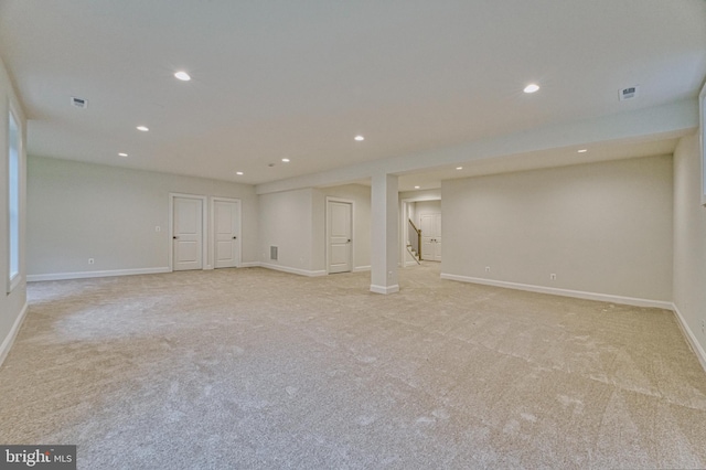 basement featuring light colored carpet