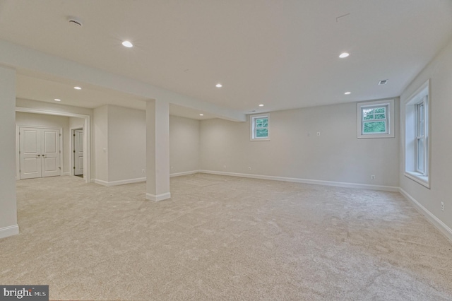 basement featuring light colored carpet