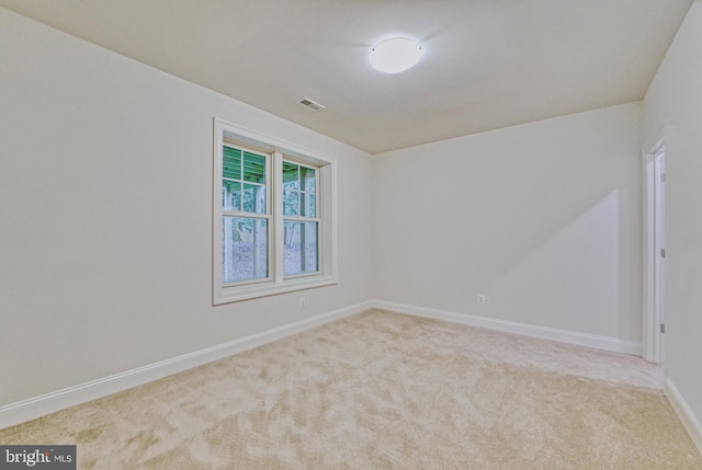 empty room featuring light carpet