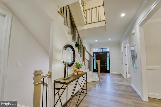 entrance foyer with light wood-type flooring and crown molding