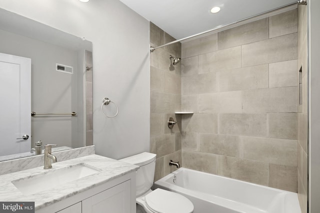 full bathroom with vanity, toilet, and tiled shower / bath