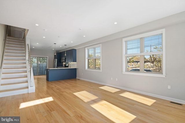 unfurnished living room with light hardwood / wood-style floors