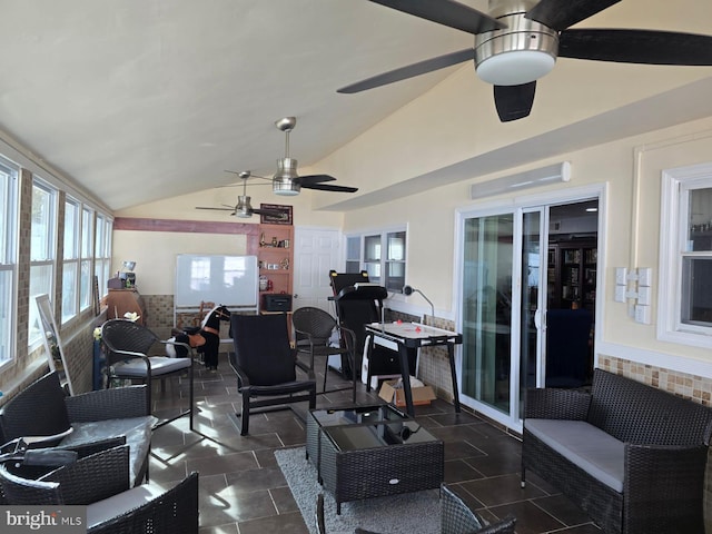 sunroom featuring ceiling fan and vaulted ceiling