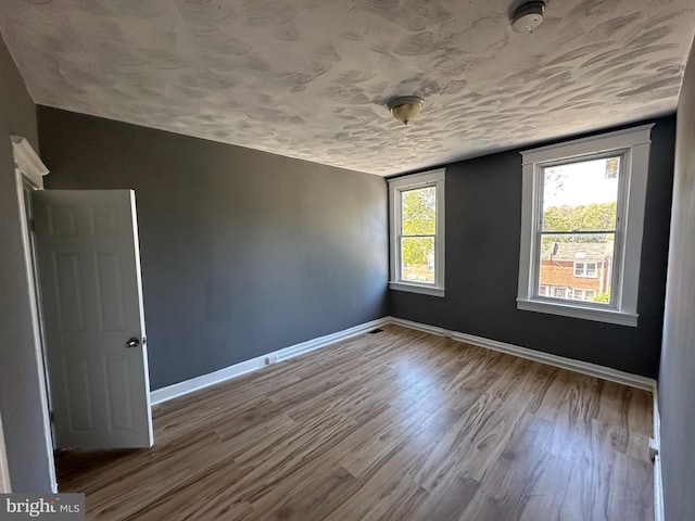 spare room with wood-type flooring