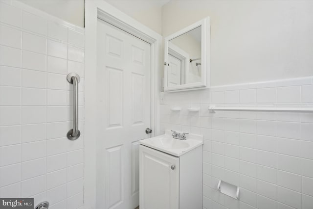 bathroom with tile walls and vanity