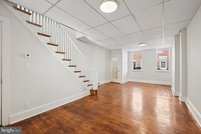 basement featuring hardwood / wood-style flooring and a drop ceiling