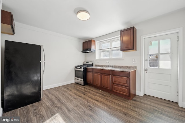 kitchen featuring appliances with stainless steel finishes, a healthy amount of sunlight, sink, and dark hardwood / wood-style floors