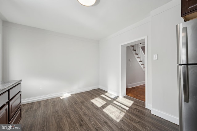 interior space featuring dark wood-type flooring and crown molding