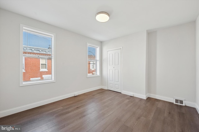 spare room with wood-type flooring