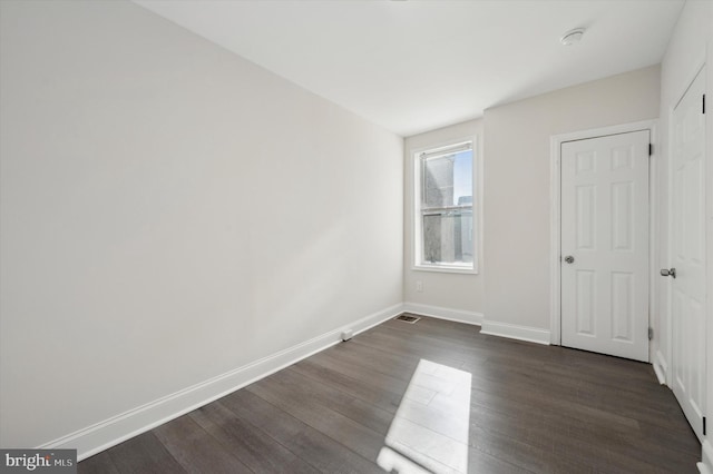 empty room featuring dark wood-type flooring