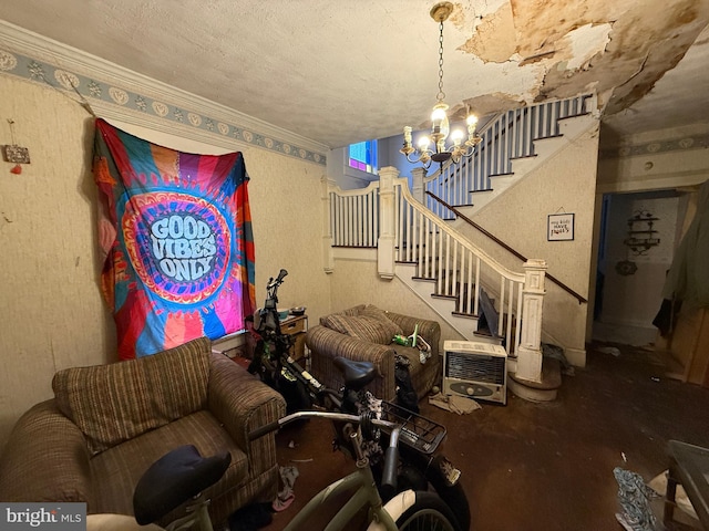 living room featuring a notable chandelier, ornamental molding, a textured ceiling, and heating unit