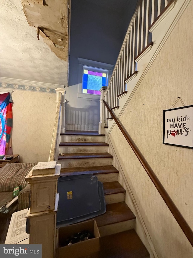 stairs with a textured ceiling