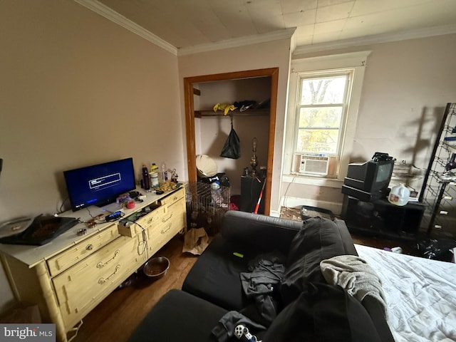 bedroom featuring cooling unit, ornamental molding, and dark wood-type flooring