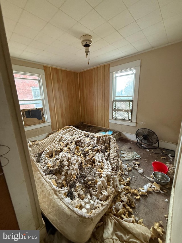 bedroom with wood walls