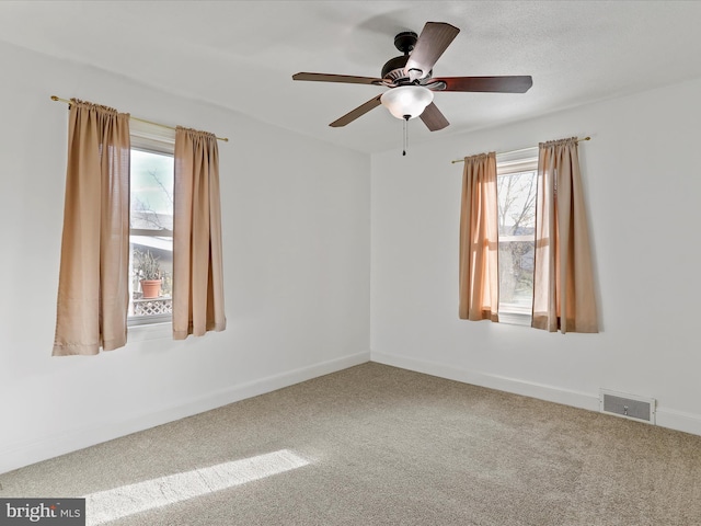 unfurnished room with carpet flooring and ceiling fan