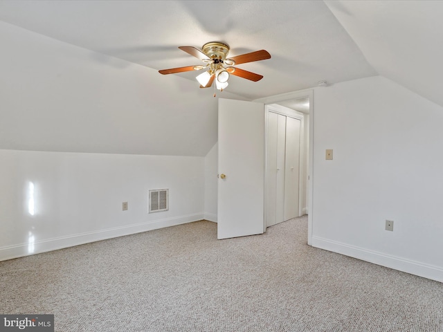 additional living space with light colored carpet, ceiling fan, and lofted ceiling