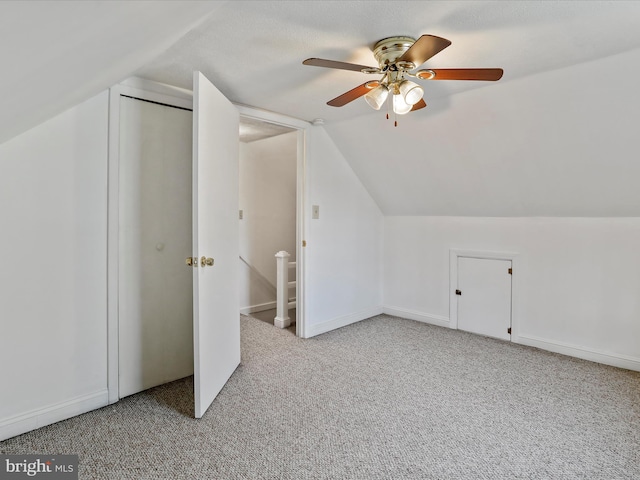 additional living space with ceiling fan, light carpet, and vaulted ceiling