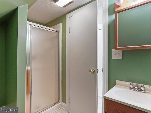 bathroom featuring sink, a textured ceiling, and walk in shower