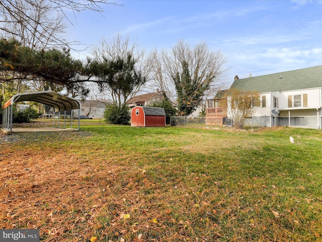 view of yard featuring a storage unit and a carport