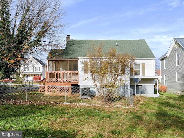 rear view of property with a lawn and central AC unit