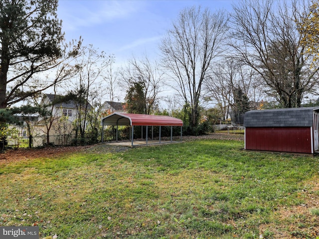 view of yard with a carport and a shed