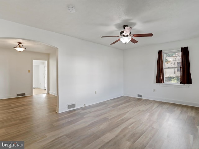 spare room featuring light wood-type flooring and ceiling fan