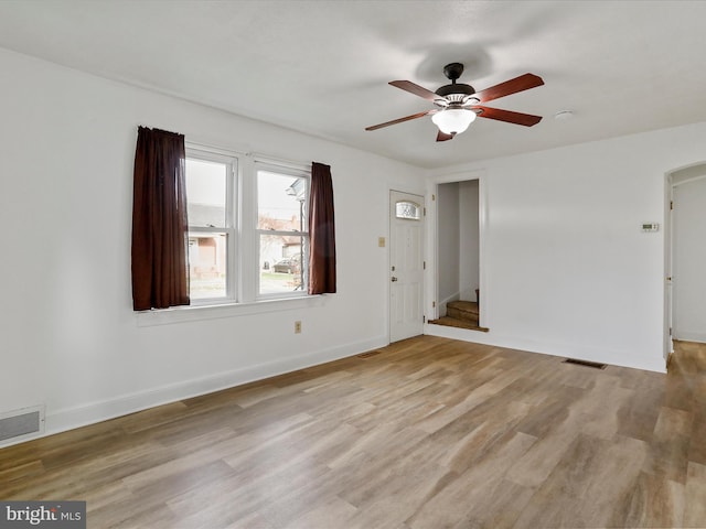 spare room featuring light hardwood / wood-style flooring and ceiling fan