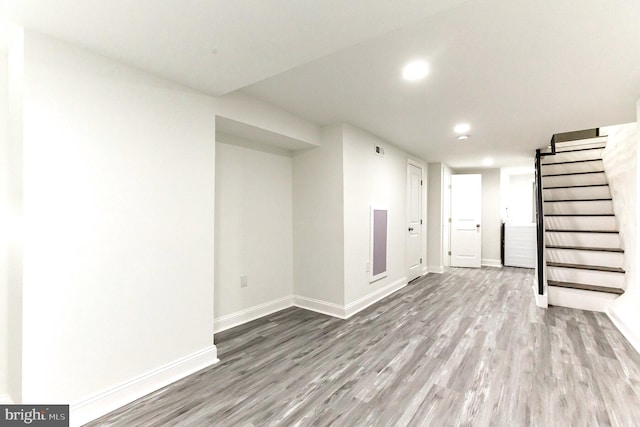 basement with light hardwood / wood-style flooring