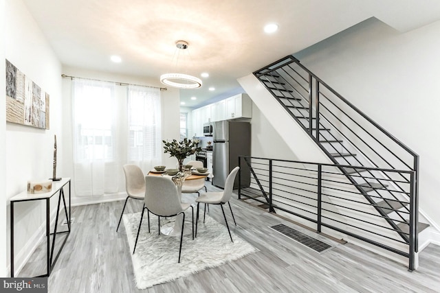 dining area featuring light wood-type flooring