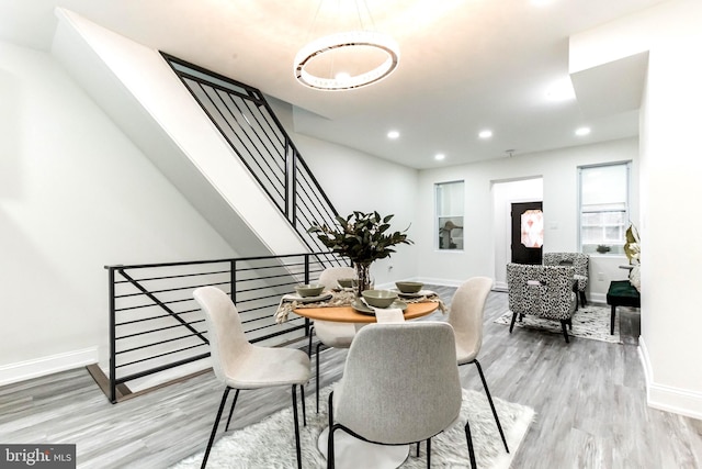 dining space with wood-type flooring