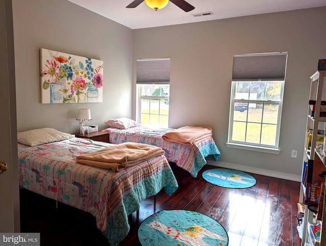 bedroom with ceiling fan and dark wood-type flooring