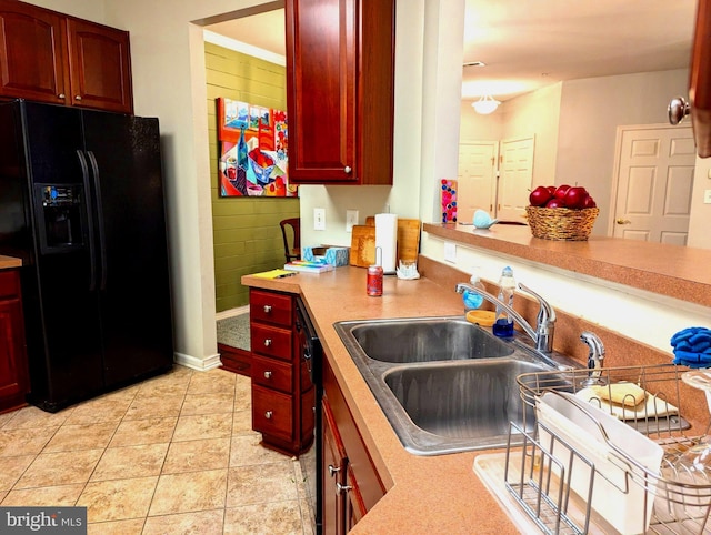 kitchen featuring black appliances, light tile patterned floors, and sink