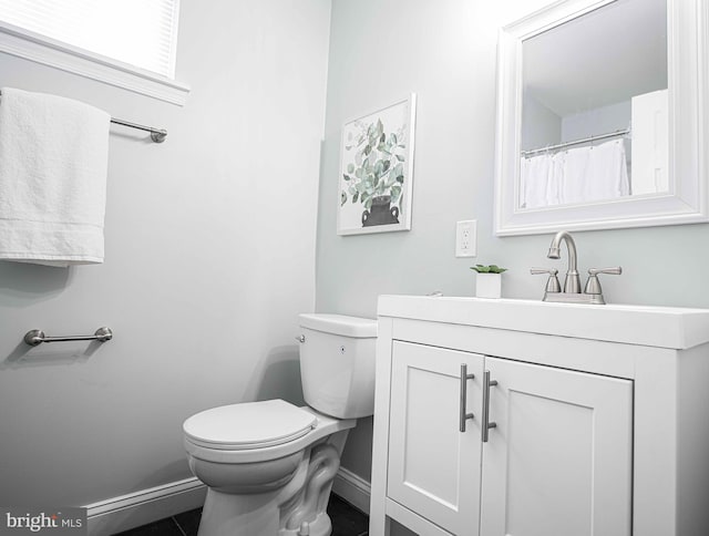 bathroom featuring tile patterned floors, vanity, and toilet