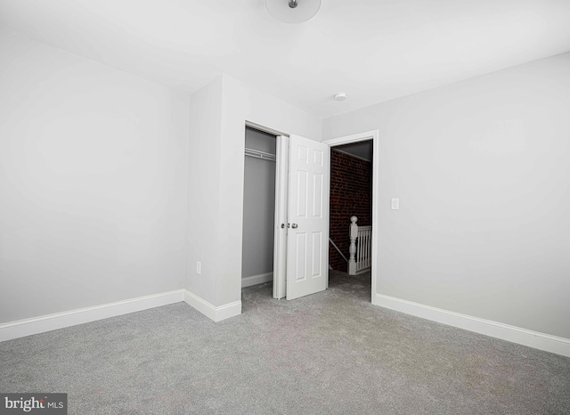 unfurnished bedroom featuring carpet floors and a closet