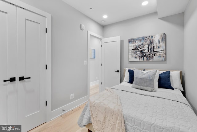 bedroom with hardwood / wood-style flooring and a closet