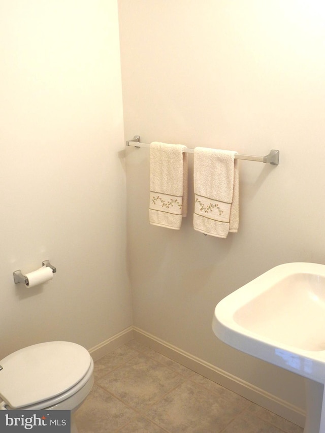 bathroom featuring tile patterned flooring and toilet